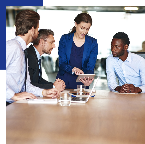 Business team reviewing tablet in meeting