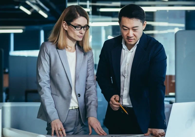Two professionals reviewing architectural plans