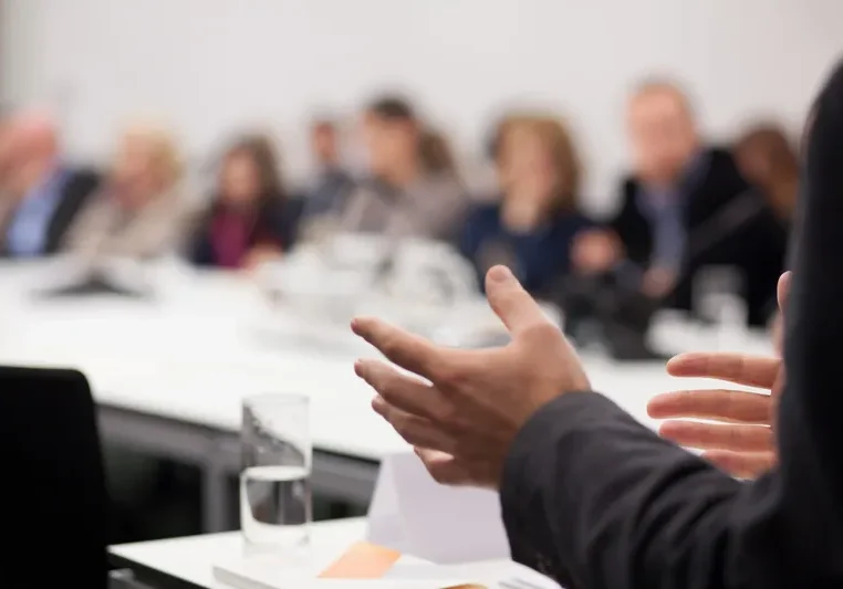 Business meeting discussion with blurred audience