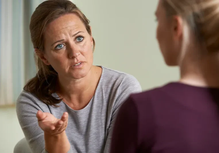 Two women having a conversation indoors