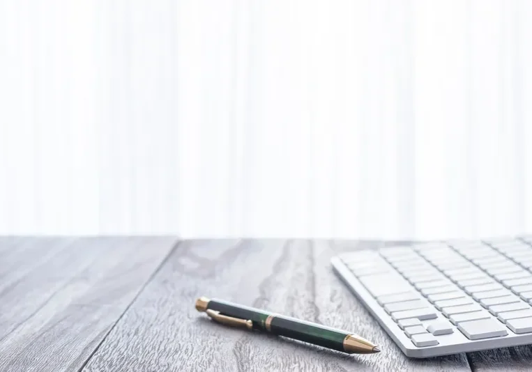 Office desk with pen and keyboard